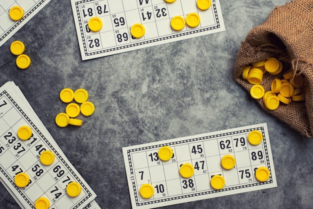 Foto oude tafelblad spel lotto kaarten bingo op grijze achtergrond met kopie ruimte bovenaanzicht