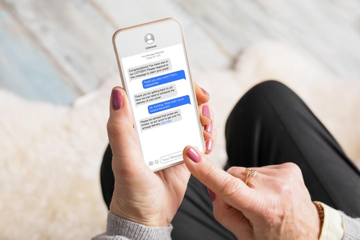 Foto oude vrouw ontvangt oplichtingsberichten op haar mobiele telefoon