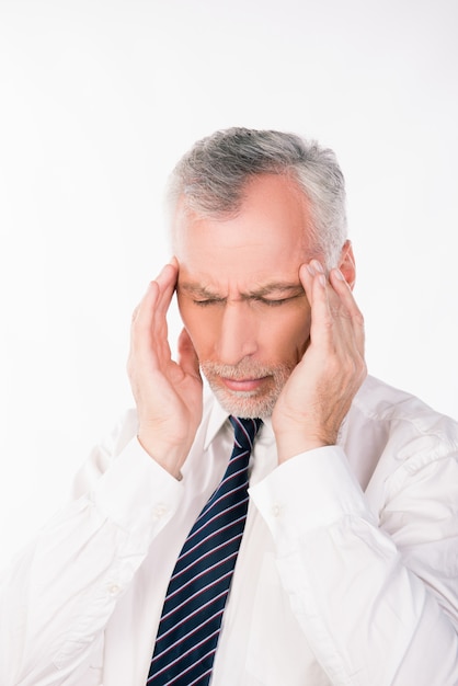 Oude zakenman die aan migraine lijdt