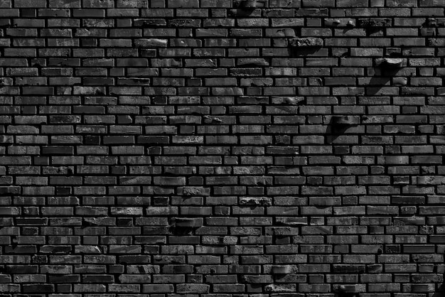 Oude zwarte bakstenen muur achtergrond