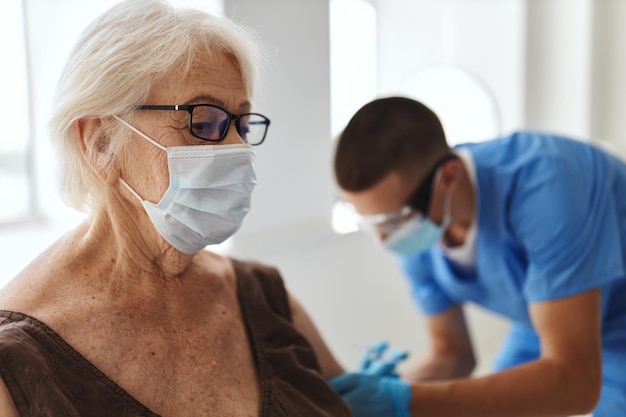 Oudere vrouw in het ziekenhuis bij de afspraak van de dokter COVID-19 vaccinatie paspoort Hoogwaardige foto