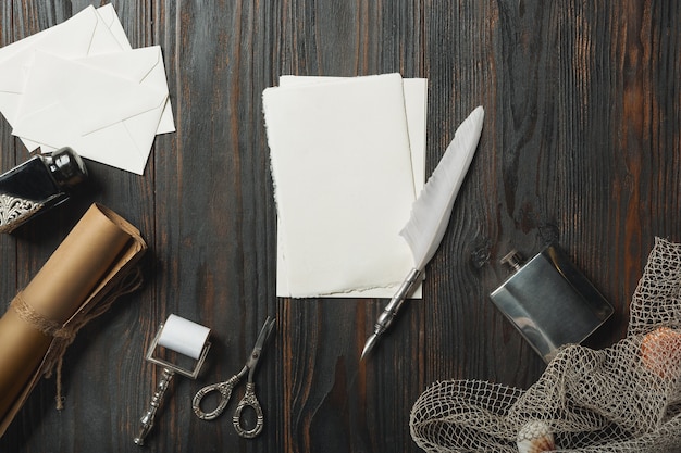 Ouderwetse flat lag met letters schrijven accessoires op donkere houten muur