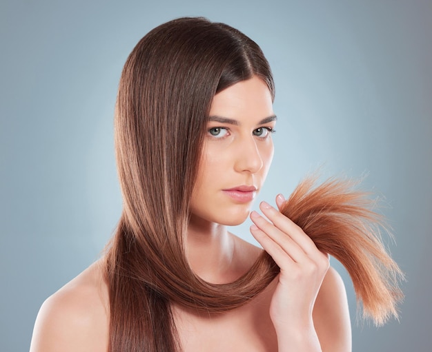 our hair is a fundamental expression of our uniqueness. Studio shot of a beautiful young woman showing off her long brown hair.