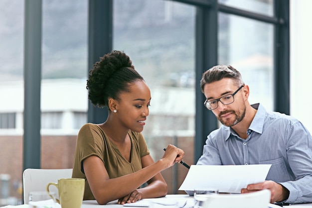 Our latest reports are looking positive Cropped shot of two colleagues having a meeting in an office