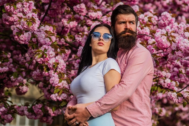 Our place of power Positive vibes Fashion people Spring collection Bearded hipster hug pretty girl Travel together Ideas for spring vacation Couple relaxing in garden Spring inspiration