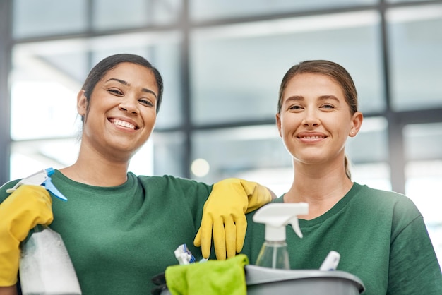 Our reputation is as spotless as your office Portrait of two young woman cleaning a modern office