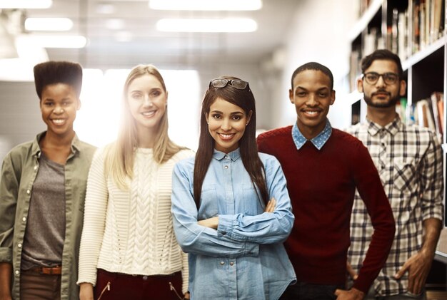 Our successful careers start with a good education Portrait of a group of university students standing together in the library on campus