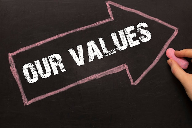 Photo our values - chalkboard with arrow on black background