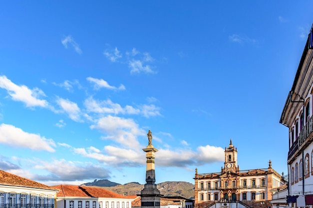 Ouro preto central square with its historic colonial-style buildings and mountains lit by the late afternoon sun