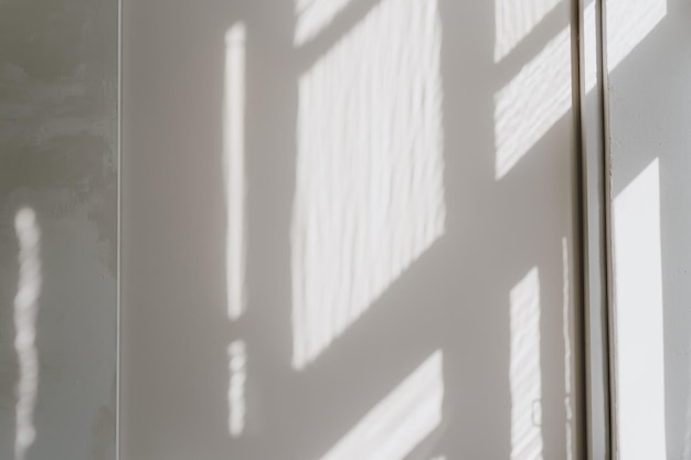 Out of focus abstract window sunlight shadow background on neutral white concrete wall Aesthetic blurred texture of sun light shadow