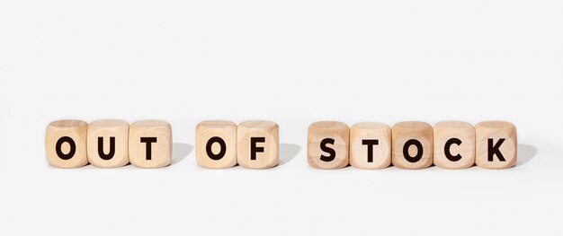 Out of stock concept. Sign in wooden blocks on white. Copy space