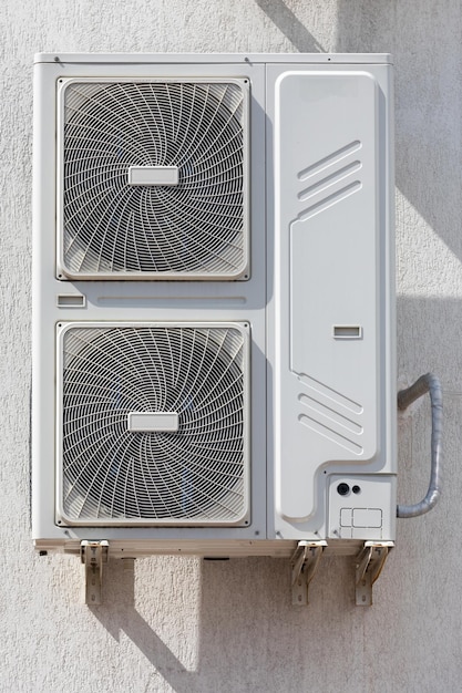 Outdoor air conditioner unit with heat exchanger hanging outside the building