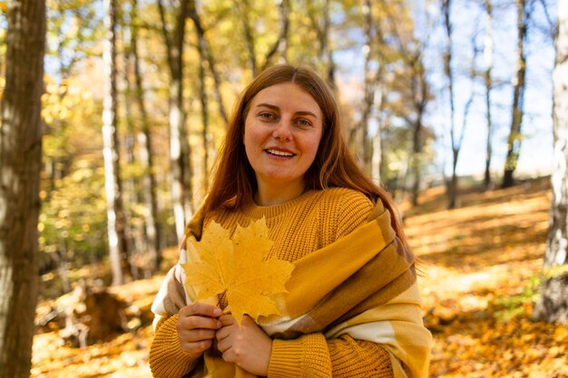 Outdoor atmospheric lifestyle portrait of young beautiful lady warm autumn high quality photo