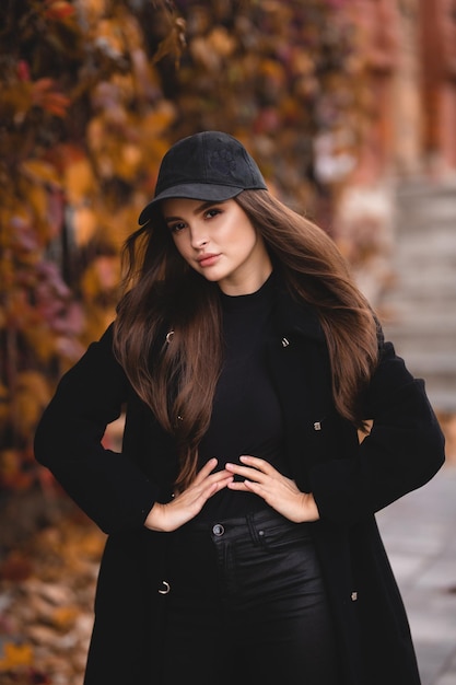 Outdoor autumn portrait of young elegant fashionable woman wearing trendy sunglasses and coat