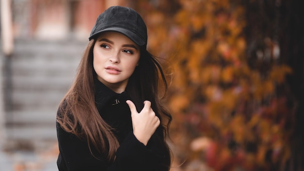 Outdoor autumn portrait of young elegant fashionable woman wearing trendy sunglasses and coat