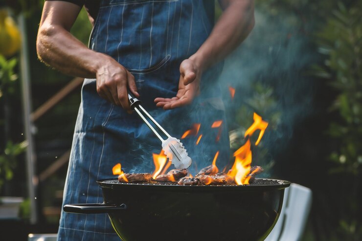 Outdoor Barbecue and Grilling BBQ Chef Preparing Food on Grill in Street Food Scene
