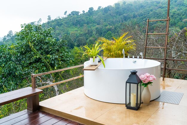 Outdoor bath tub with beautiful mountain view background