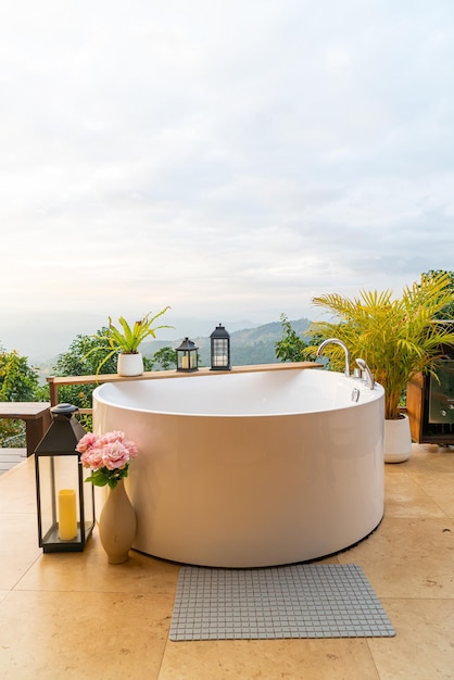 Outdoor bath tub with beautiful mountain view background