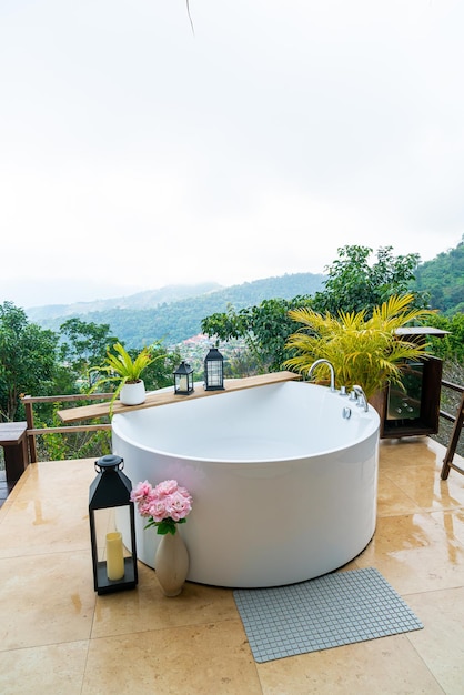 outdoor bath tub with beautiful mountain view background