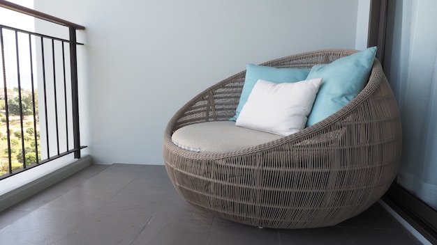 outdoor beach chair on the hotel room balcony or terrace which made from natural wood called rattan 