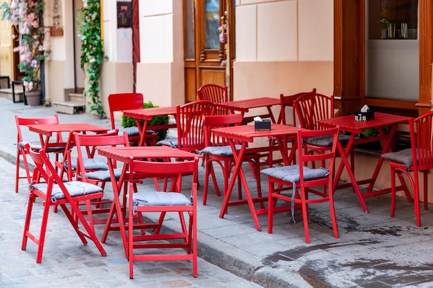 Outdoor cafe in the old town Chairs and table on empty terrace at cafe