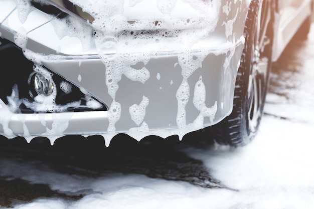 Outdoor car wash with foam soap.