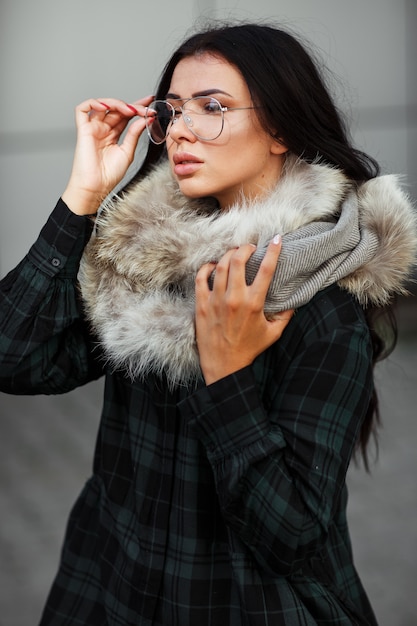 Outdoor close up fashion portrait of young beautiful confident woman wearing trendy shirt