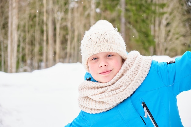 Outdoor closeup portrait of young beautiful happy smiling girl in winter park