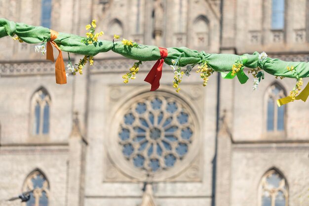 Outdoor Easter decorations on streets of Prague rose window of St Ludmila Church in background Peace square Czech Republic