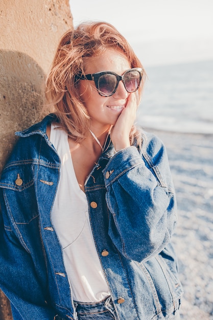 Outdoor fashion portrait of stylish woman on the beach.