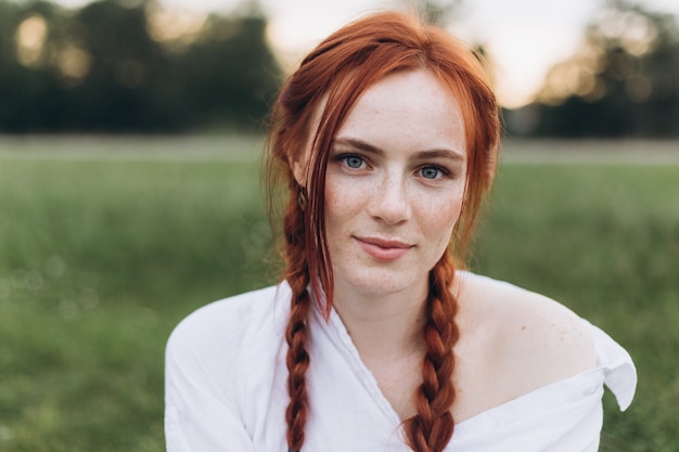 outdoor ginger woman portrait with pigtails