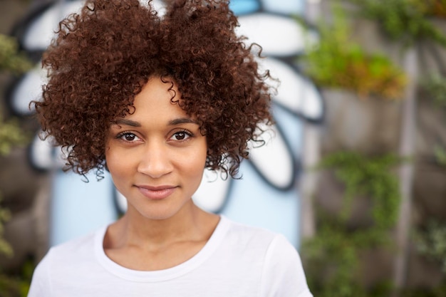 Outdoor Head And Shoulders Portrait Of Smiling Young Woman