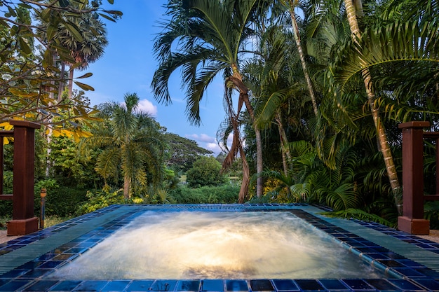 Outdoor jacuzzi amongs greenery garden