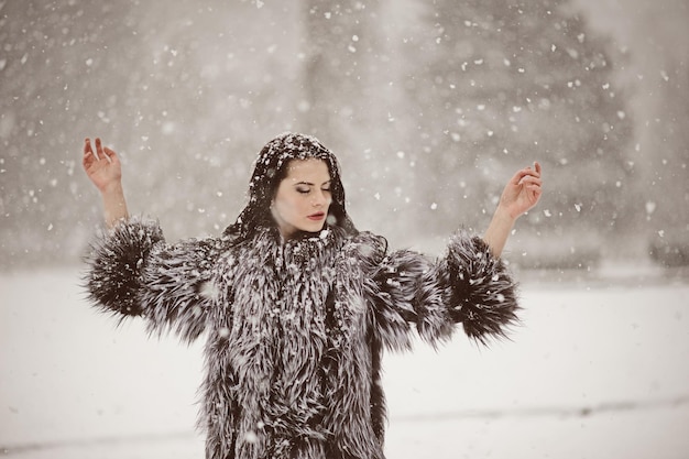 Outdoor lifestyle fashion photo of young natural beautiful lady in winter landscape