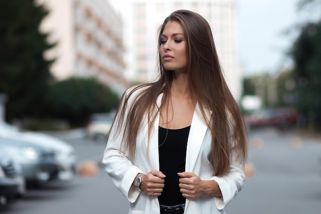 Outdoor lifestyle portrait of amazing glamorous luxury woman posing in city