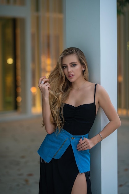 Outdoor lifestyle portrait of pretty young fashion model in urban background outdoor elegant fashion