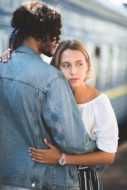 Outdoor lifestyle portrait of young loving couple in the old city on the street