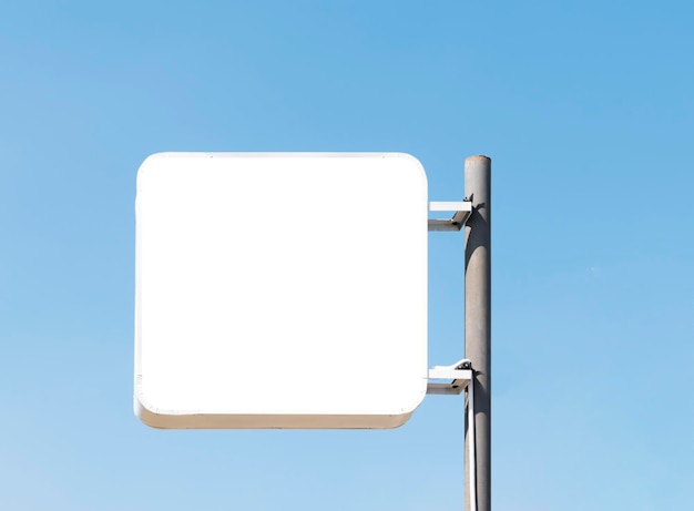 Outdoor pole billboard on blue sky background with mock up white screen and clipping path