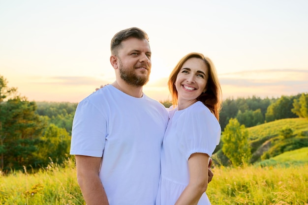 Outdoor portrait of adult happy loving hugging couple