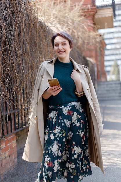 Outdoor portrait of an attractive stylish short cut woman