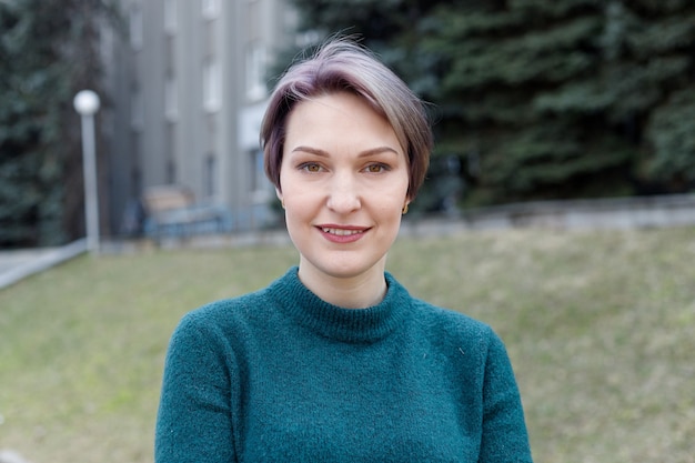 Outdoor portrait of an attractive stylish short cut woman