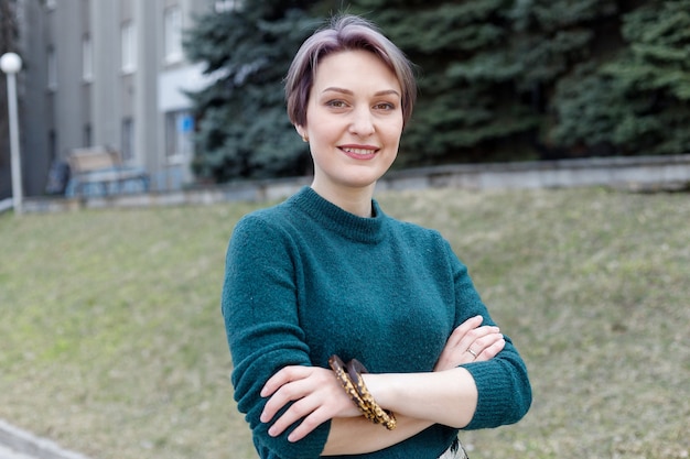 Outdoor portrait of an attractive stylish short cut woman