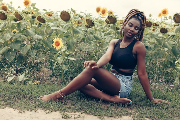 Outdoor portrait of beautiful girl in a field of yellow flowers