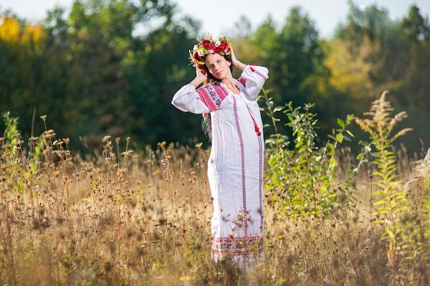 Outdoor portrait of beautiful pregnant Ukrainian woman