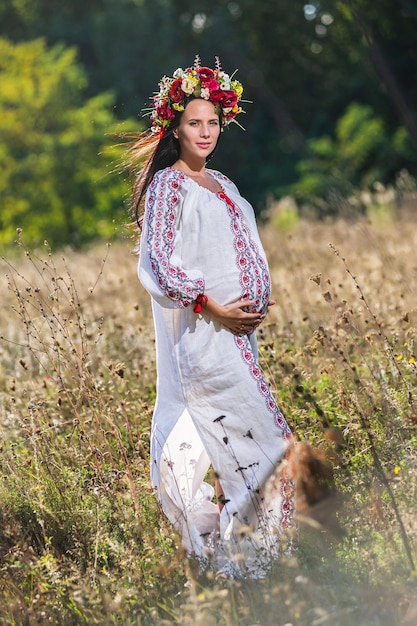 Outdoor portrait of beautiful pregnant Ukrainian woman