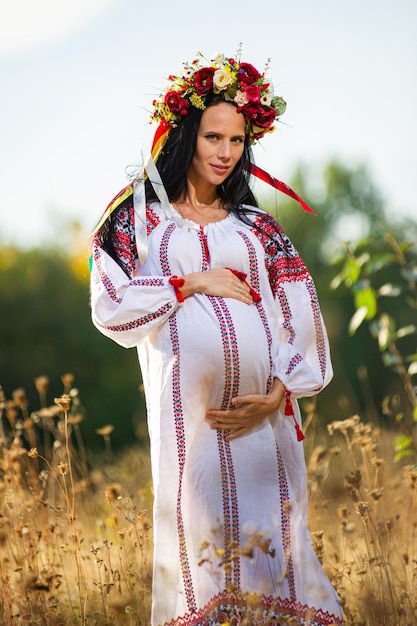Outdoor portrait of beautiful pregnant Ukrainian woman