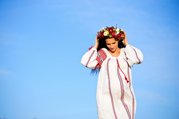 Outdoor portrait of beautiful pregnant Ukrainian woman