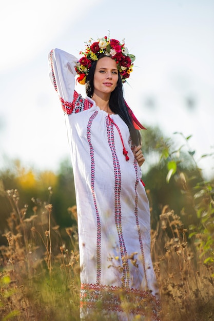 Outdoor portrait of beautiful pregnant Ukrainian woman