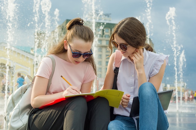 Outdoor portrait of girls student with backpacks