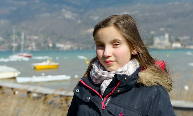 Outdoor portrait of a little girl in a black jacket